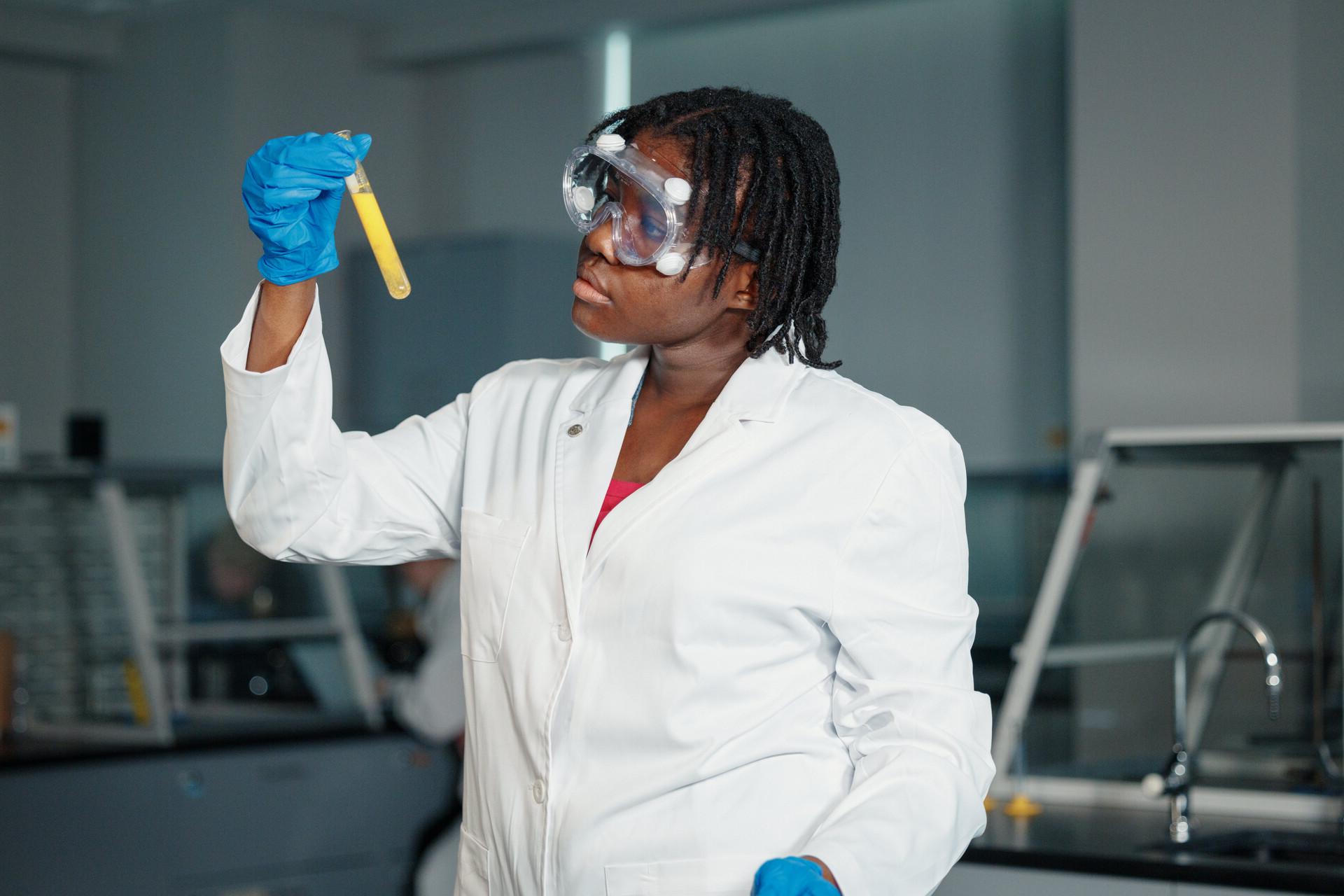 A scientist filling a needle with a liquid